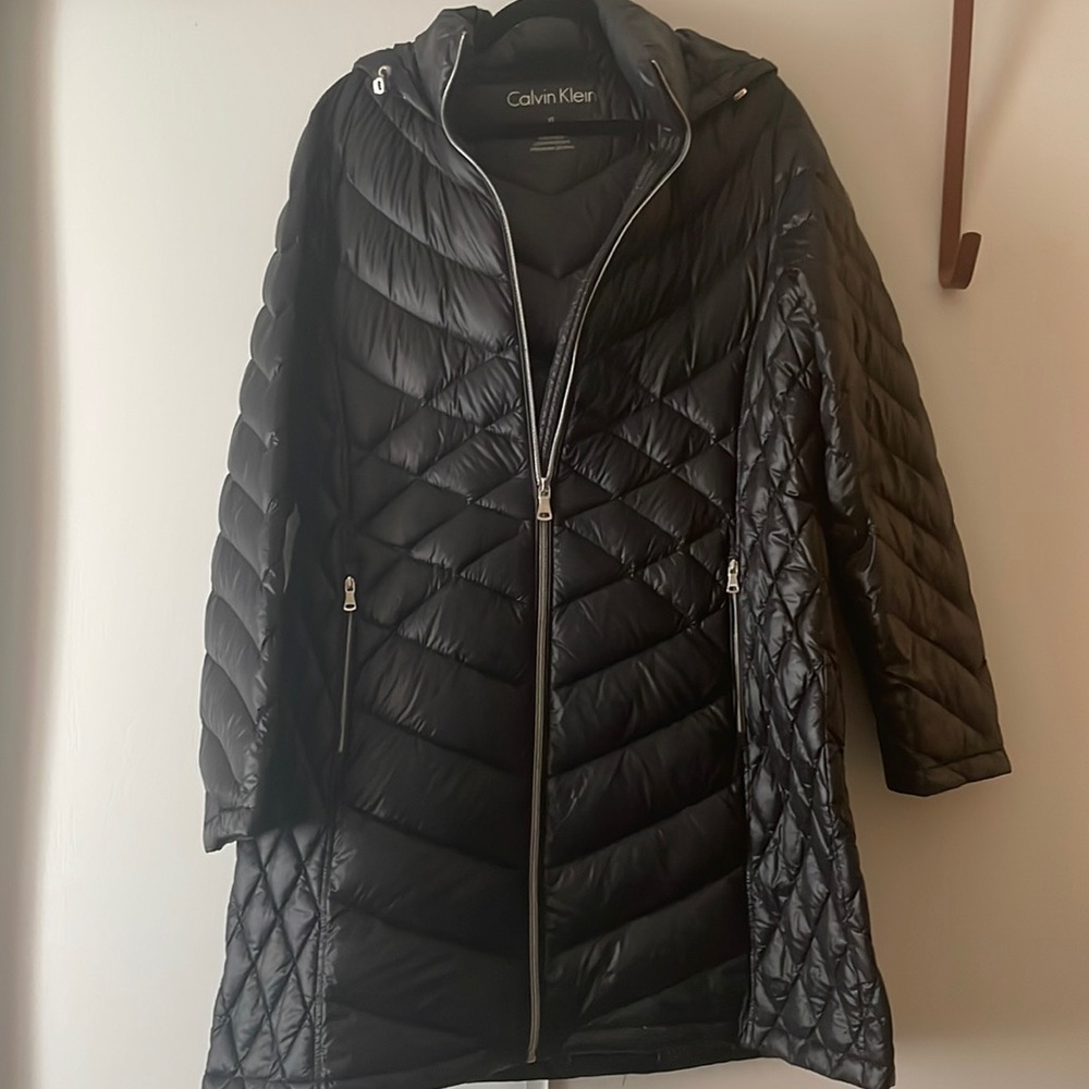 I am sellling a black Calvin Klein puffer it does run a bit long